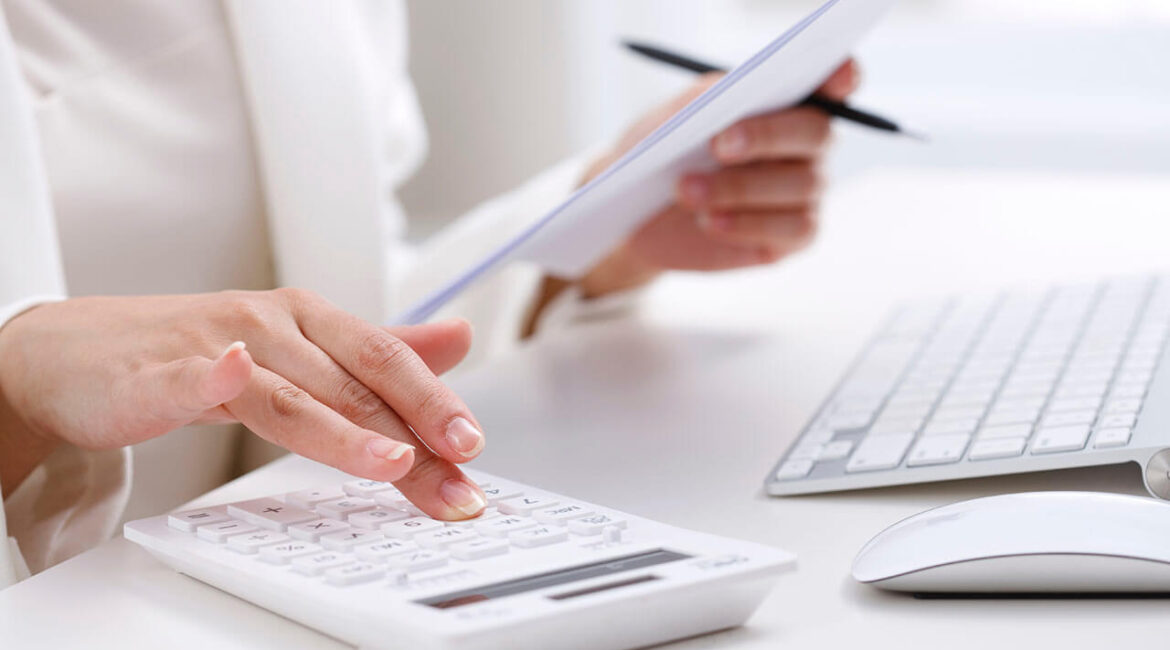 Woman work on white calculator