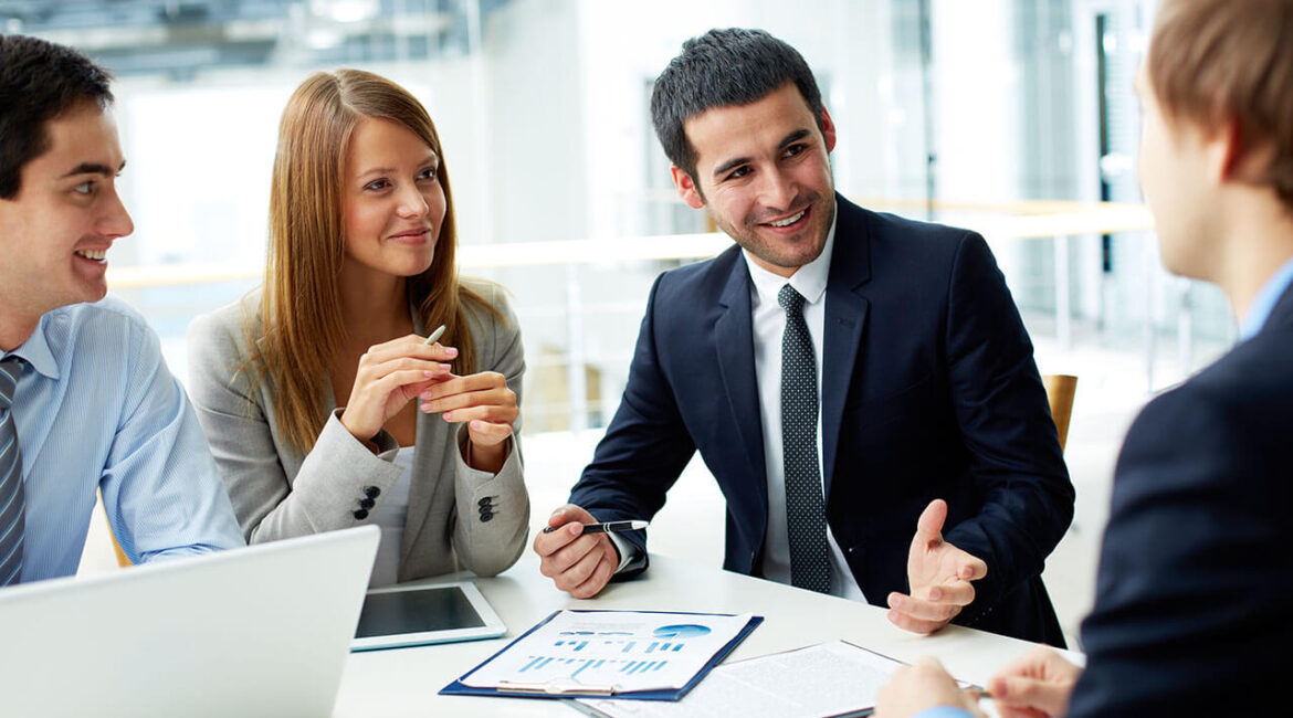 Four people are discussing a project